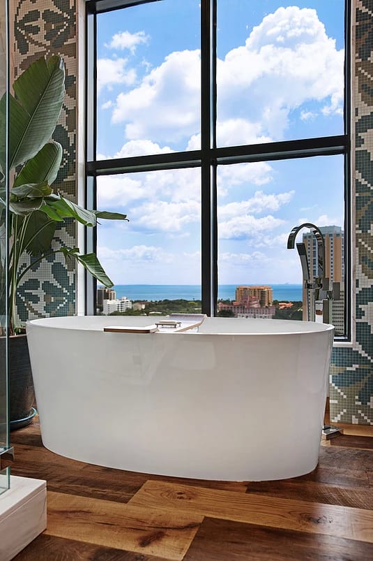 Bath tub near the glass window