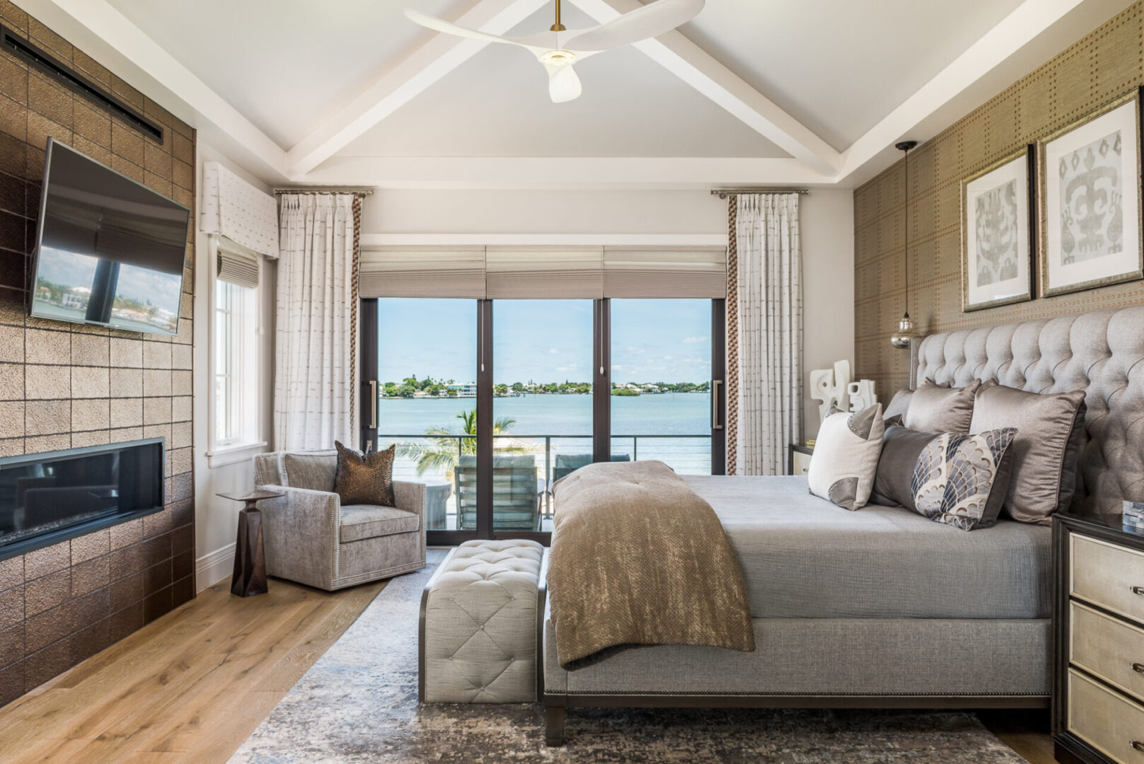 A Bedroom Overlooking a Lake With Silk Throw Pillows