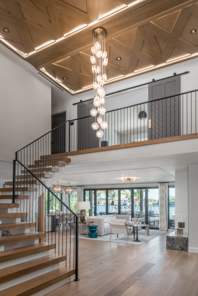 A large open living room with stairs leading to the second floor.