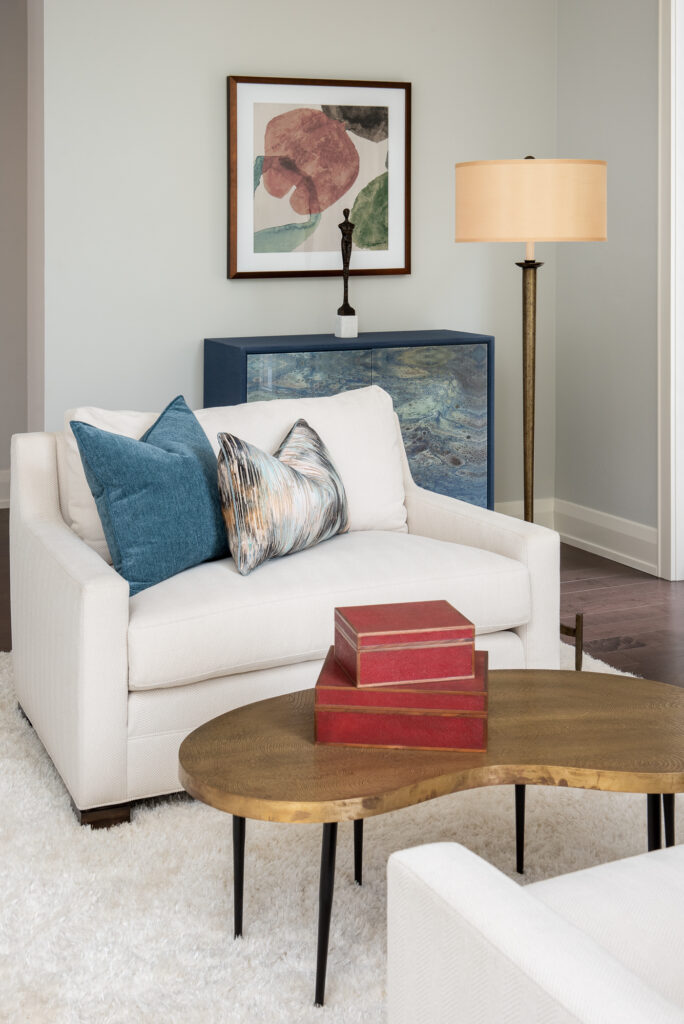 A living room with a white couch and wooden table