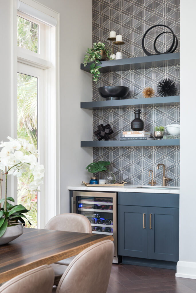 A kitchen with blue cabinets and shelves in it