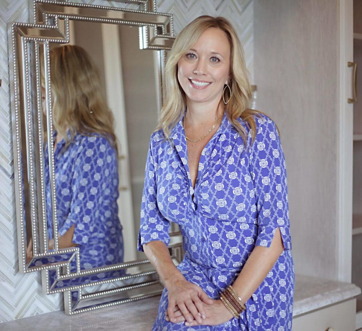Smiling woman in blue patterned dress